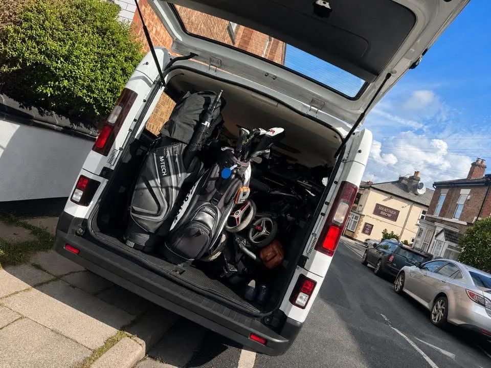 Golf bags clubs and trolleys loaded in rear of Ventus long-wheelbase minibus